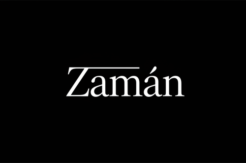 A luxury minimalist watch brand logo with the name “Zamān” (with the macron on the ā), set on a pure black background (#000000). The text is in elegant white typography, refined and timeless, inspired by Arabic calligraphy fused with modern serif lettering. High contrast, premium feel, subtle curves, balanced spacing, no extra symbols. Sophisticated, high-end Swiss watch aesthetic. Flat design, vector-style logo, sharp edges, ultra-clean, no shadows, no gradients, no mockups.